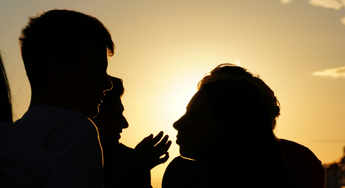 Silhouettes of people talking.