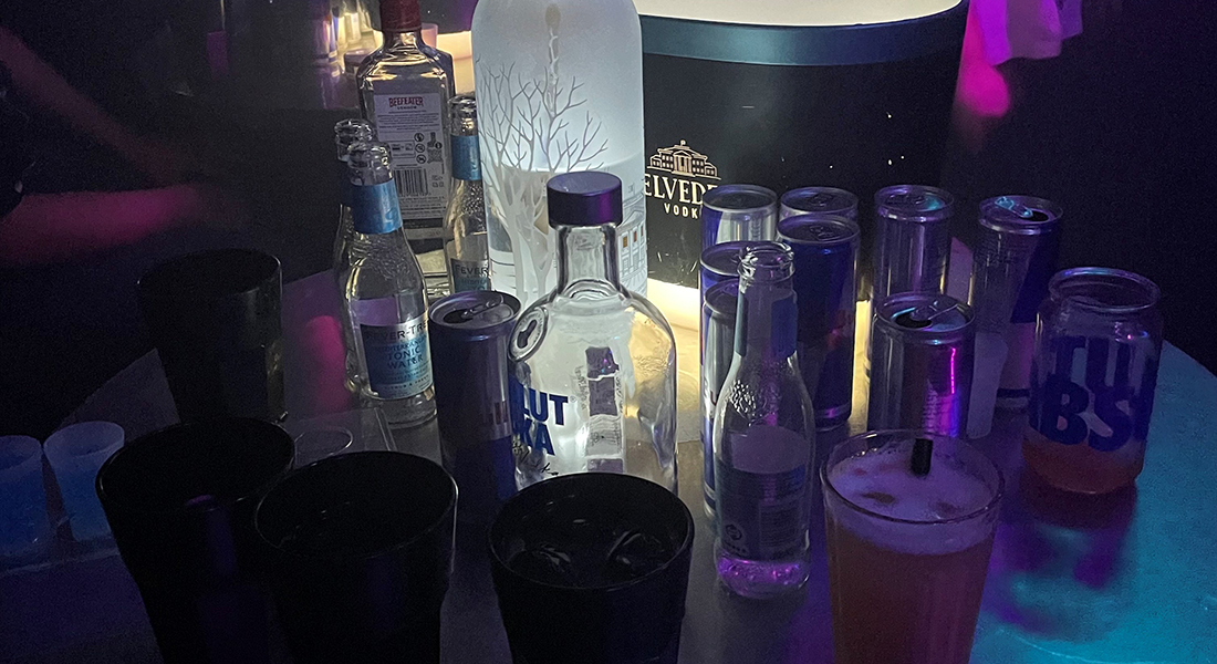 Table with bottles and glasses. Table with bottles and glasses.