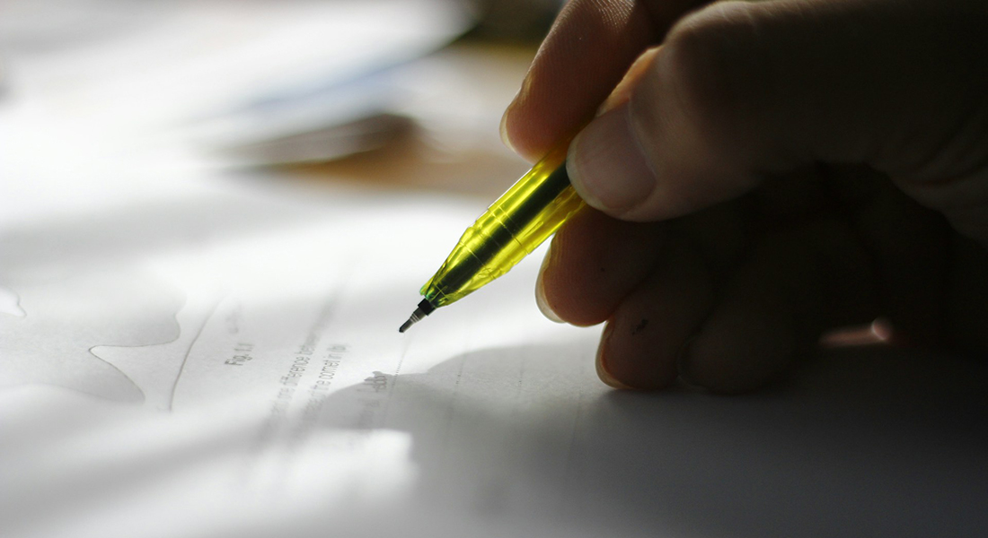 Hand completing a test. Hand completing a test.