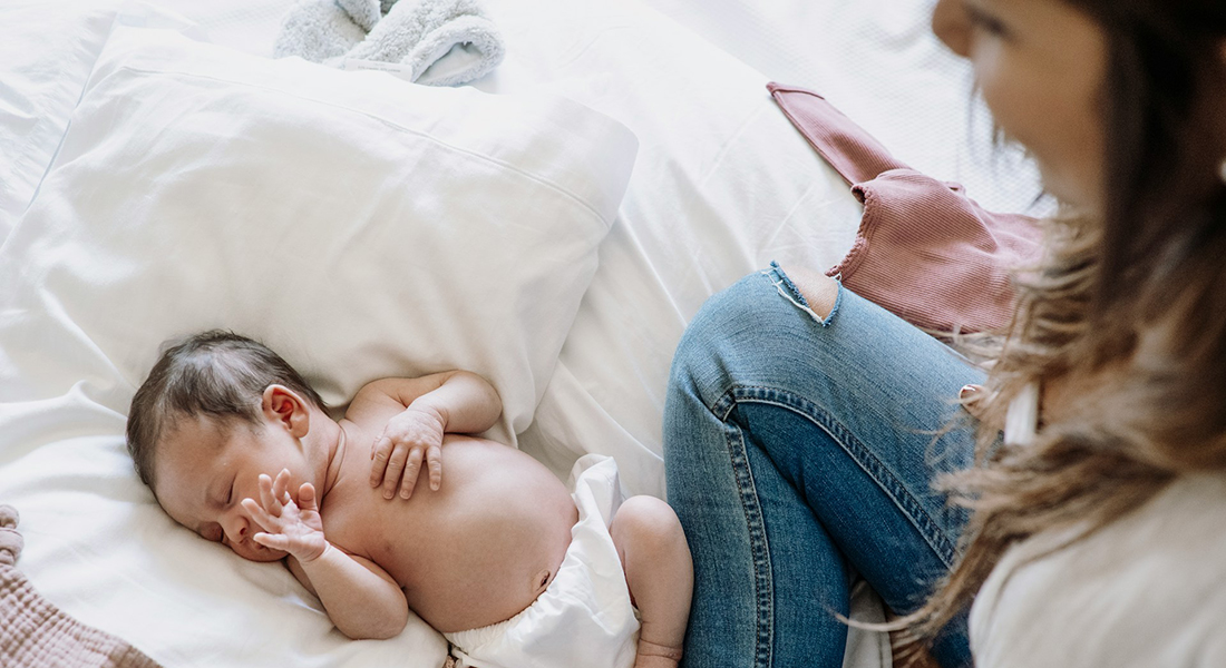 Mother looking at infant. Mother looking at infant.
